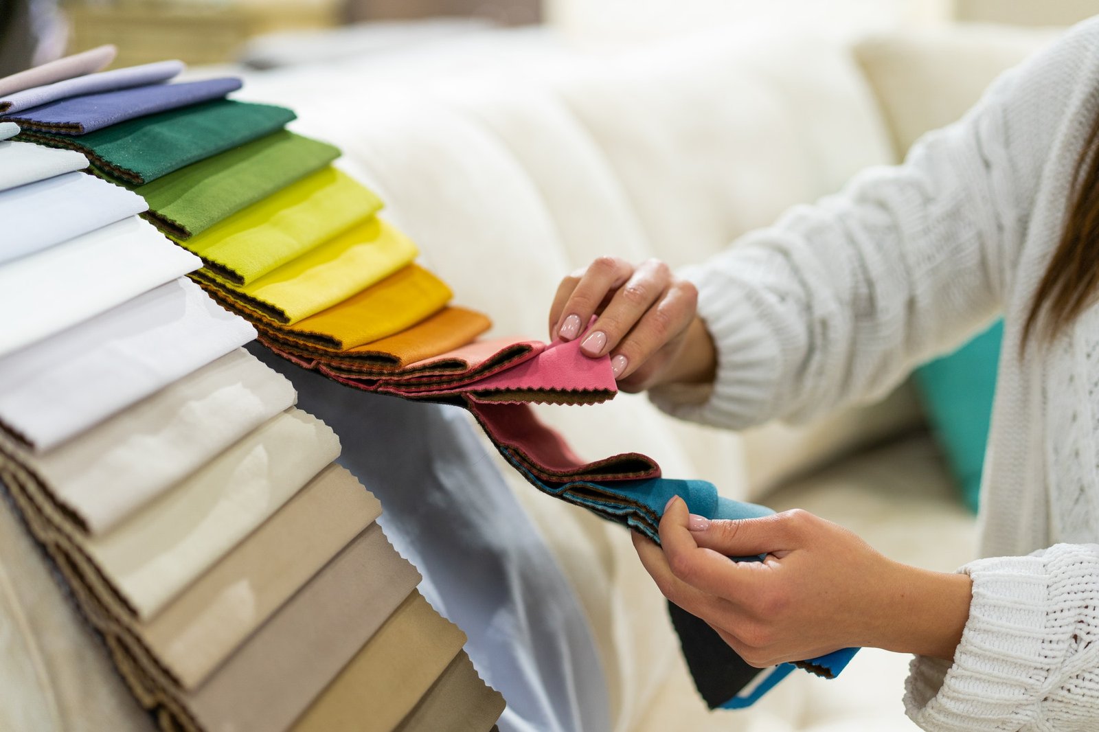 the-woman-chooses-the-fabric-on-the-sofa-textile-industry-background-tissue-catalog.jpg